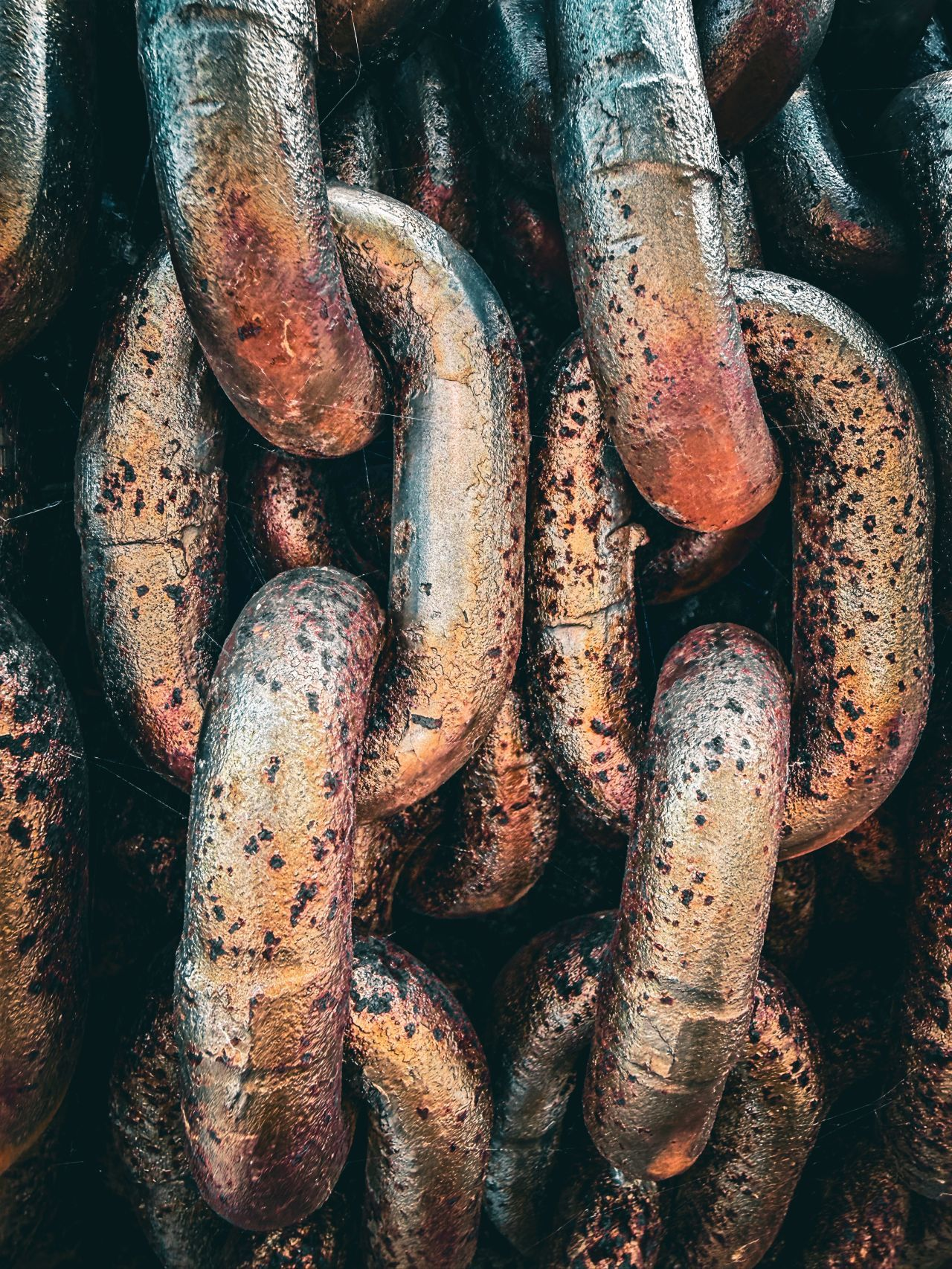 a close-up of rusted, weathered iron chain links