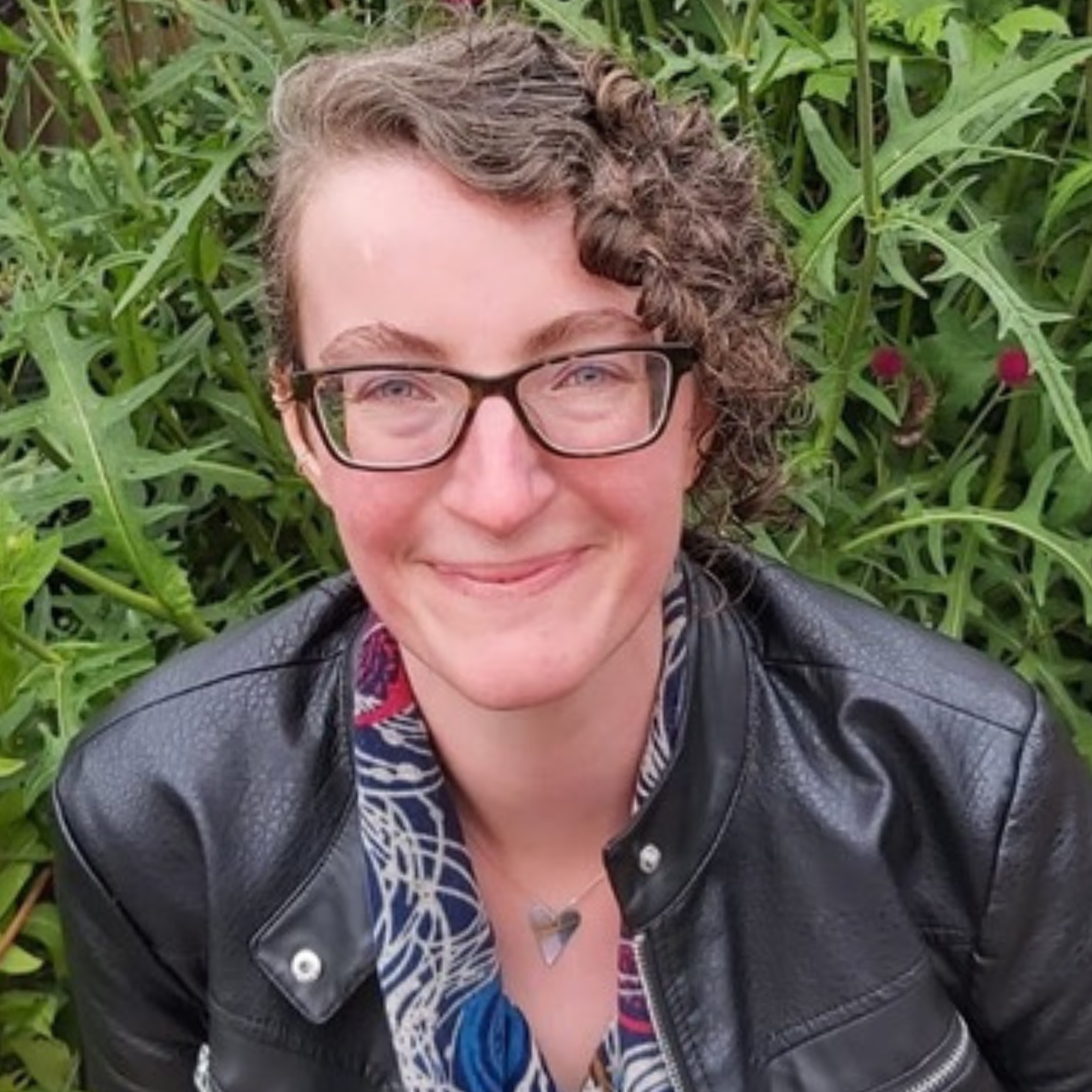 Val smiling in a garden